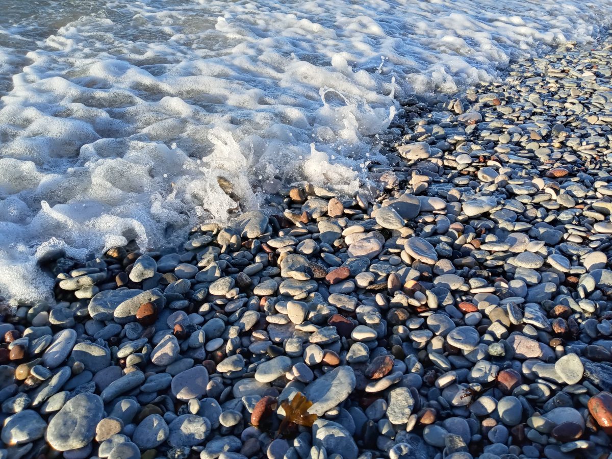photo of waves against rocks on beach along Baltic Sea