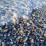 photo of waves against rocks on beach along Baltic Sea