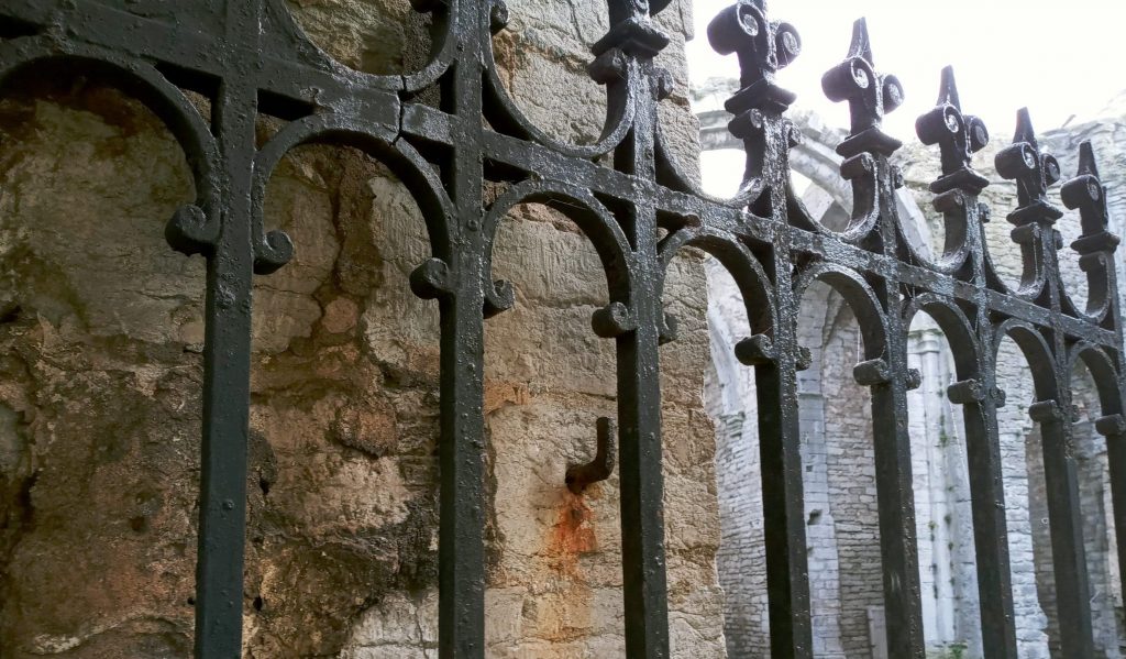 photo of wrought iron gate on medieval ruins