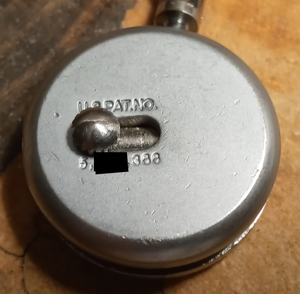 Redacted photo of key ring product with patent marking notice that says "U.S.Pat.No. 5,[],366"